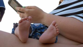 Woman using cellphone while baby sleeping video