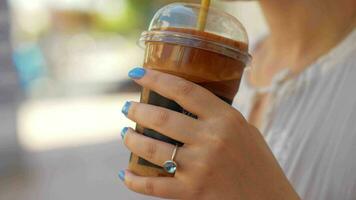 Woman drinking chocolate cocktail in the street video