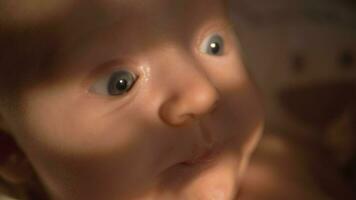 Baby girl portrait, sun light on her eyes video