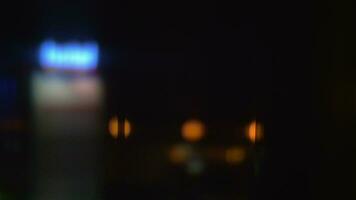 Window view to night street with illuminated hotel banner video