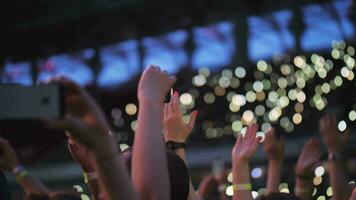 Music fans at the concert People applauding and making cell videos