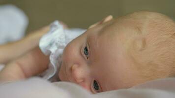 A closeup of a baby girl lying on a belly video