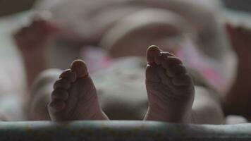 Baby in rocking chair, view to little feet video