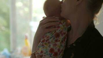 Loving and careful mother with baby daughter at home video