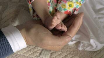 Baby feet in dad hand video