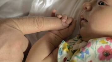 Baby girl holding parents finger video