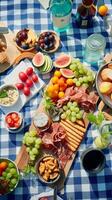 aéreo ver de un verano picnic exhibiendo al aire libre comida en un a cuadros cobija ai generativo foto