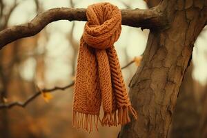 A golden hand-knitted scarf made of Australian wool, hanging on a tree branch. Symbol of hope and compassion, reminder of the kindness and generosity of strangers. AI Generated. photo