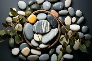 Arrangement of smooth stones and eucalyptus on a grey stone surface. Peace and tranquility atmosphere. AI Generated. photo