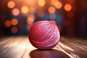un pelota de brillante hilo con un liso, incluso textura en un de madera mesa. ai generado. foto
