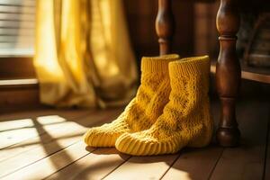 A pair of yellow crocheted socks made of a thick, knitted material on a wooden floor. Warmth and coziness concept. AI Generated. photo