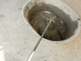 Concrete is mixed in a concrete mixing bowl photo