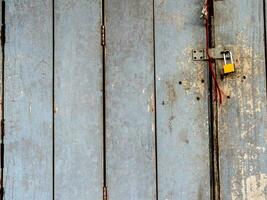 Old wooden folding door locked with a key photo