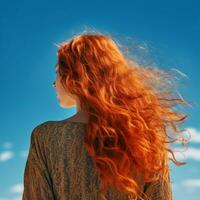 young man with red and curly hair on the city street .back view. photo