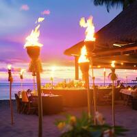 Hawaii luau beach party at sunset. Hawaiian tiki torches lighted up with fire at luxury resort hotel restaurant. AI Generative photo