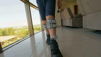 Boy with foot drop system walking indoor video