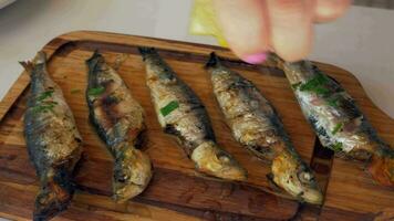 Pouring sardines with lemon juice before eating video