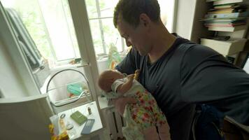 papá arrullando bebé hija a hogar video
