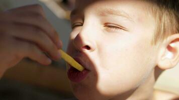 Kid eating fries outdoor video