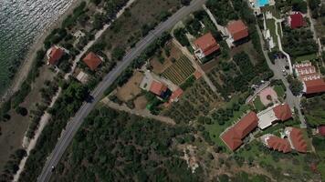 Flying over the cottages on seafront of Trikorfo Beach, Greece video