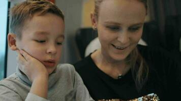 kind en moeder voorbijgaan de tijd met stootkussen gedurende trein reis video