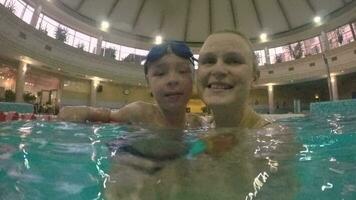 Happy and loving mother with son in the pool video