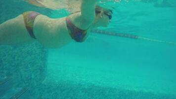 Underwater view of pregnant woman swimming in the pool video