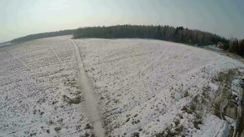 Dorf mit riesig schneebedeckt Felder in der Nähe von das Wald, Antenne Aussicht video