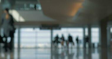 Airport terminal with walking people, defocus video