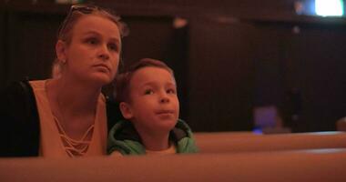 Mom and kid spending leisure at the cinema video