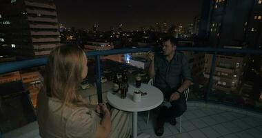 Couple spending evening in rooftop cafe of night Tel Aviv video