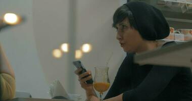 vrienden vergadering in cafe vrouw pratend en gebruik makend van mobiele telefoon video