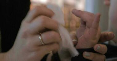 Mom cleaning sons hand with wet wipe video