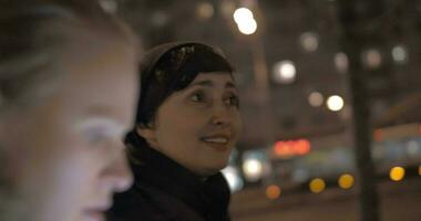 Women having friendly talk during evening walk in the city video