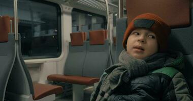 Boy in moving commuter train at night video