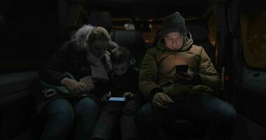 Passengers in minibus passing the time with cellphones video