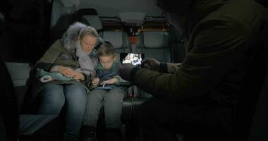 Minibus travel Taking mobile video of mom and kid playing on cellphone