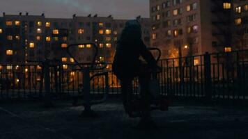 Kid on street exercise bike in the dusk video