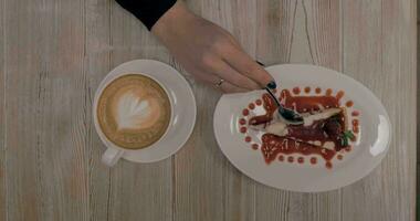 Woman having dessert with coffee in restaurant video