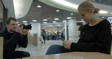 Making video of woman with smart phone in shopping mall