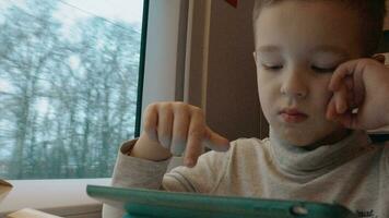 Child playing on touch pad during train ride video