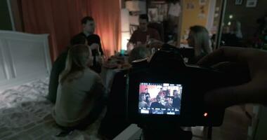 Creating a footage of friends having party at home video