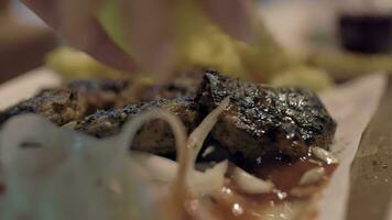 Close up view of meal on the plate, that woman waters lemon juice with potatoes, onion video