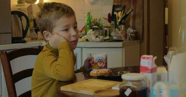 Kind beim Zuhause haben Mittagessen mit Tee und Sandwiches video