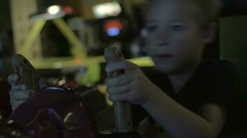 Close up view of small boy are playing video arcade game in game center