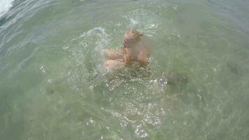 Sea wave hitting swimming woman video