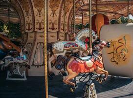 Vintage fair horse carousel in amusement park concept photo