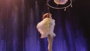 Close up view of aerial performer making acrobatic act against colorful fountains, acrobatics, Moscow, Russia video