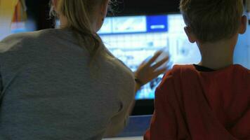 Mom and child having fun with amusement machine video