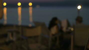 Beach cafe with couple in the evening video